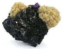 Кристаллизованные блестящие чёрные кристаллы сфалерита, в которых находятся две розетки светло-коричневого барита, а также одного кристалла флюорита лавандового цвета.